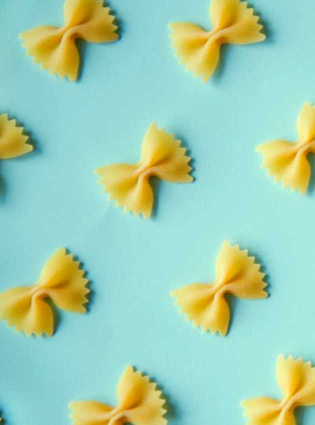 looped pasta on a pale blue background