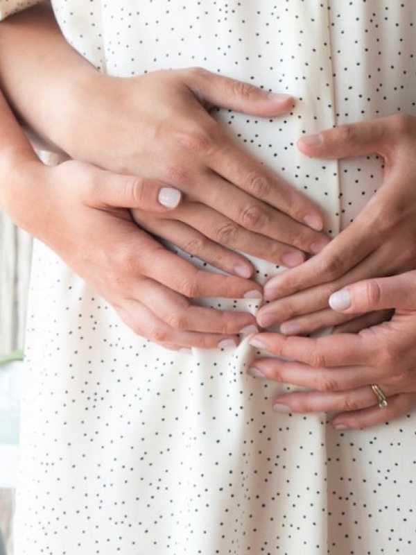 pregnant woman, nausea, hands on pregnant belly