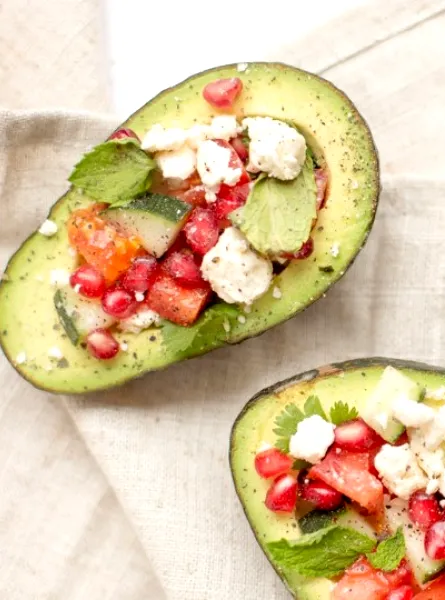 Three avocados stuffed with feta, tomatoes and mint 