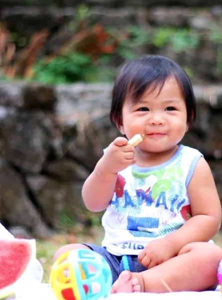 child eating at a picnic
