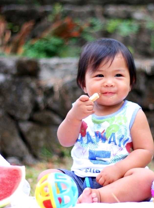 child eating at a picnic