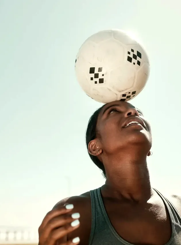 a person with a bandage on their head holding a soccer ball