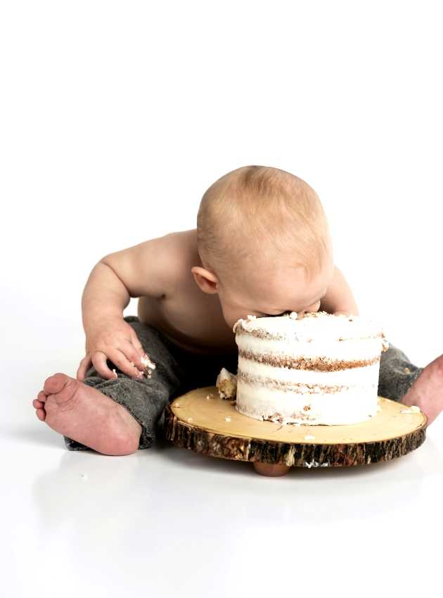 baby eating cake