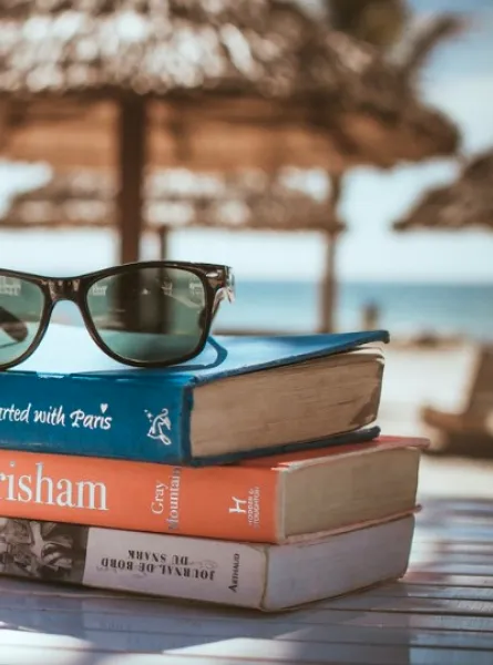 Pile of books with a view on the ocean 