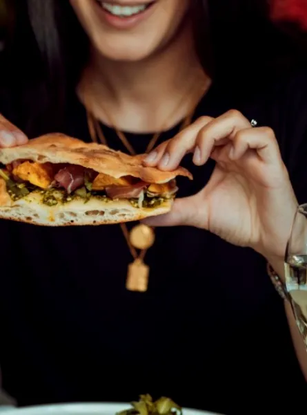 Woman eating mindfully her sandwich at a restaurant