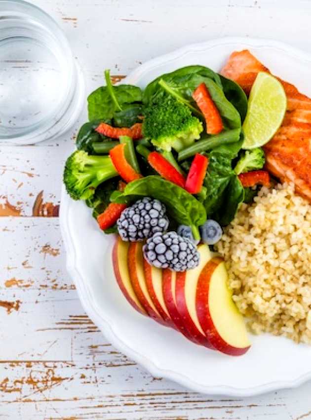 Plate with salmon, rice, salad and apple